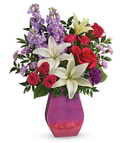 White lily, pink rose, lavender stock and purple carnations glitter vase bouquet
