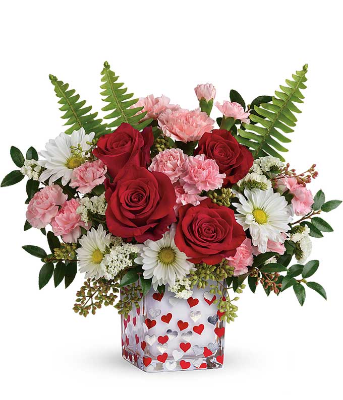 Valentines Day flower delivery with pink carnations, red roses and heart vase
