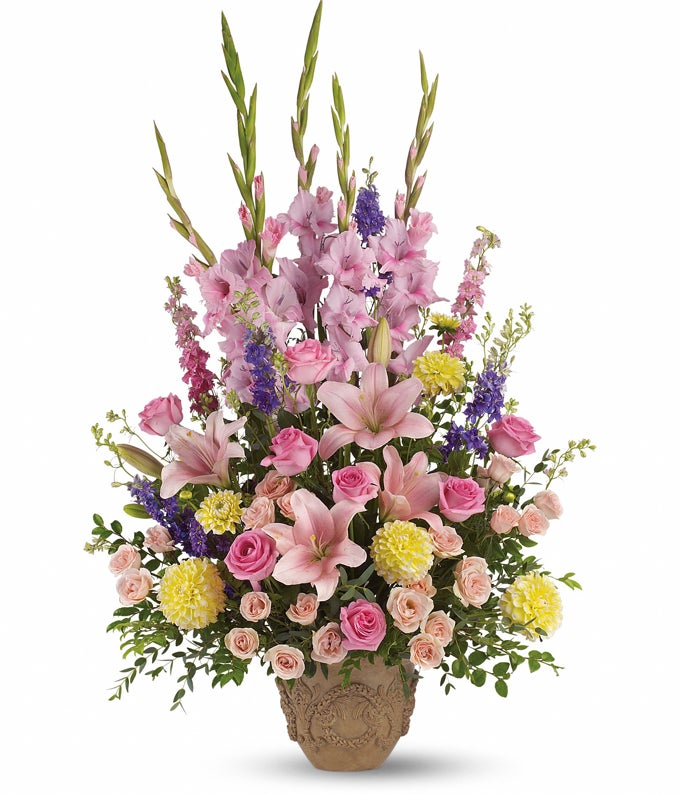 A Bouquet of Hot Pink Roses, Pink Spray Roses, Pink Hybrid Lilies, Pink Gladioli, Yellow Dahlias, Pink & Purple Larkspur, Huckleberry, and Parviflora Eucalyptus with Garland of Grace Urn