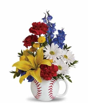 A bouquet of Blue Delphinium, Yellow Asiatic Lilies, White Daisies, and Red Carnations on a baseball designed cup