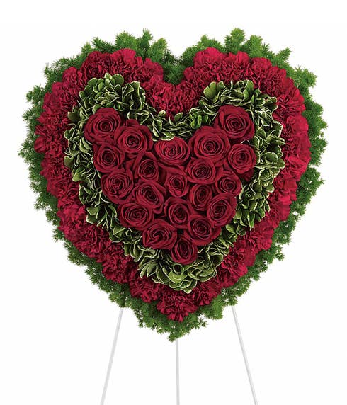 Red roses and red carnations heart shaped funeral standing spray 