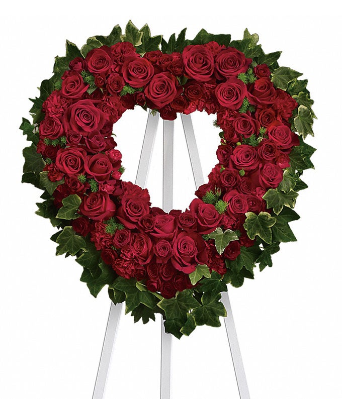 Heart-Shaped Flower Arrangement Including Red Carnations, Red Roses, Lush Ming Fern and Variegated Ivy with Easel Stand Included