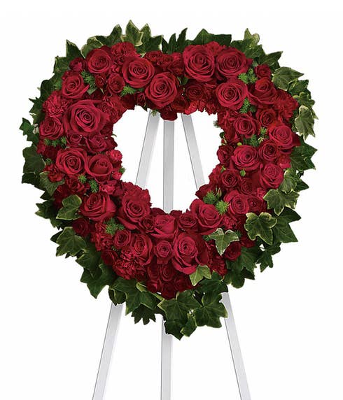Red roses and red carnations open heart funeral flowers standing spray