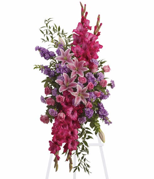 Pink oriental lily and pink rose oval funeral flowers standing spray with easel