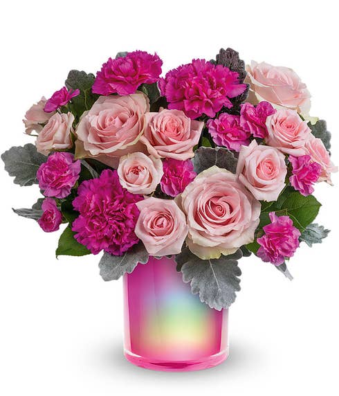 Short arrangement of pink roses and carnations, in a holographic cylinder vase