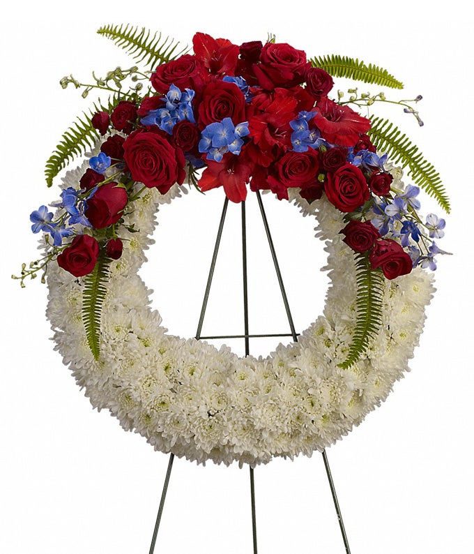 A Round Flower Arrangement Including White Chrysanthemums, Red Gladioli, Crimson Roses, Blue Delphinium, Indigo Hydrangea, and Lush Fern
