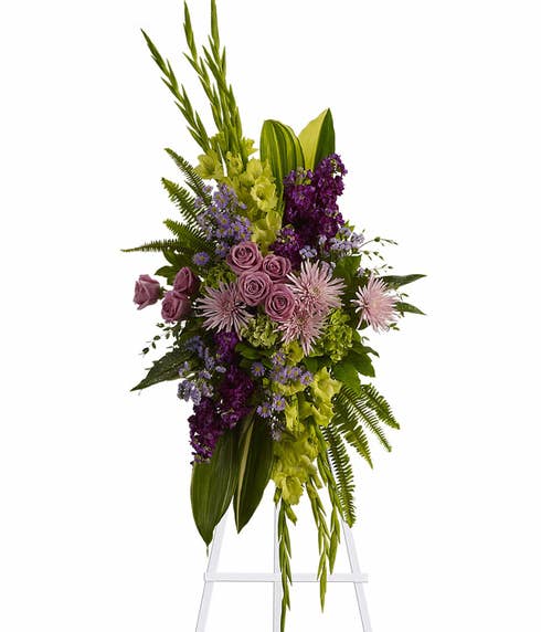 Oval shaped green cymbidium orchid and fuji mums funeral flower standing spray