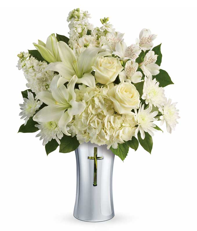 A Bouquet of White Hydrangea, White Roses, White Asiatic Lilies, White Alstroemeria, White Stock, and White Cushion Spray in a Chrysanthemums lemon leaf cross vase