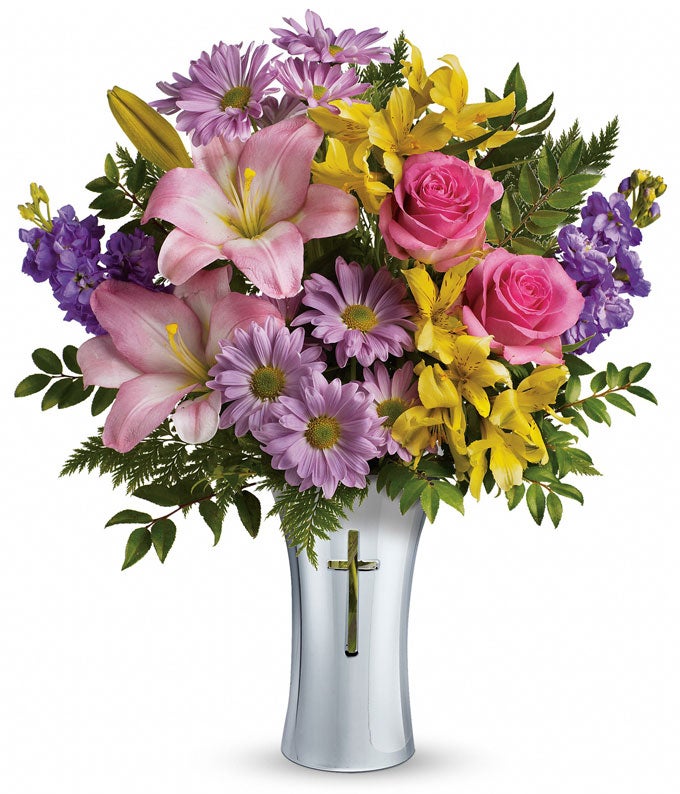 A bouquet of hot pink roses, pink Asiatic lilies, yellow alstroemeria, lavender stock, lavender daisy, spray chrysanthemums, huckleberry and  leatherleaf in a fern cross vase