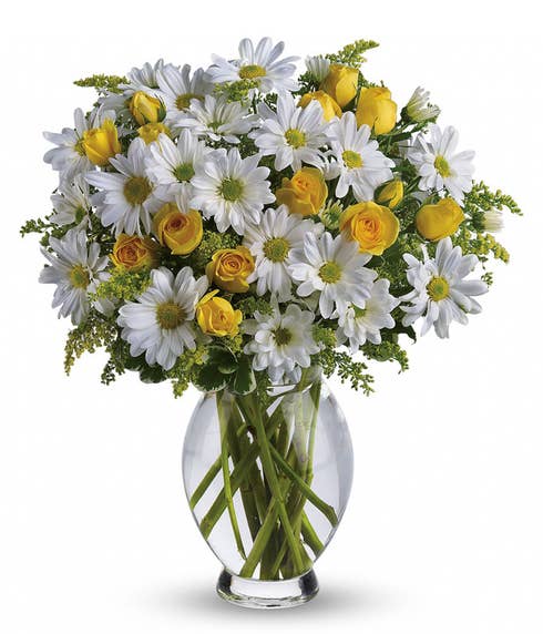 White daisy and miniature yellow roses bouquet in glass vase of spring flowers