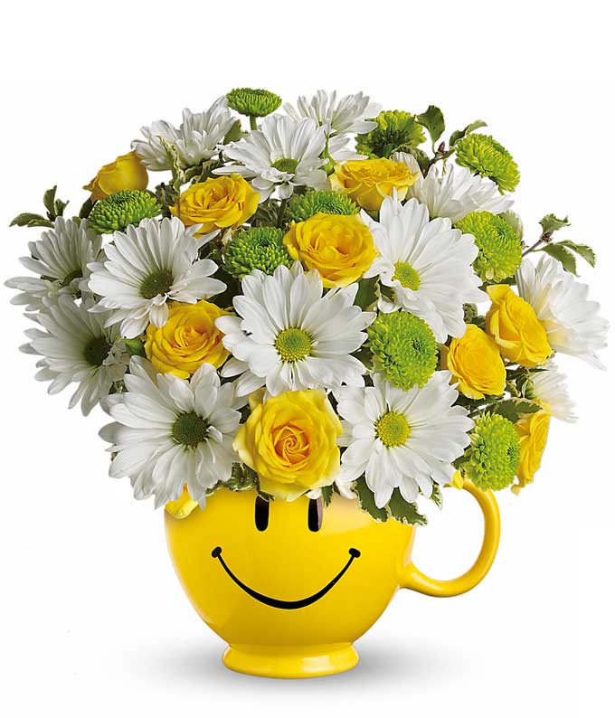 A Bouquet of White Daisy Flowers, Yellow Roses and Green Chrysanthemums Button Sprays in a Smiley Face Coffee Mug