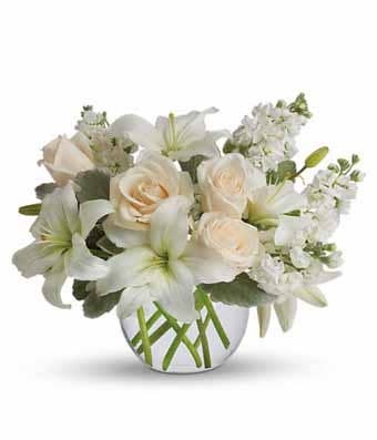 White asiatic lily and cream roses bouquet with white stock flowers and bubble vase