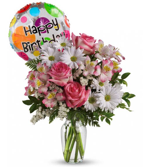 Colorful birthday bouquet of roses, lilies, and gerberas with a cheerful birthday balloon attached.