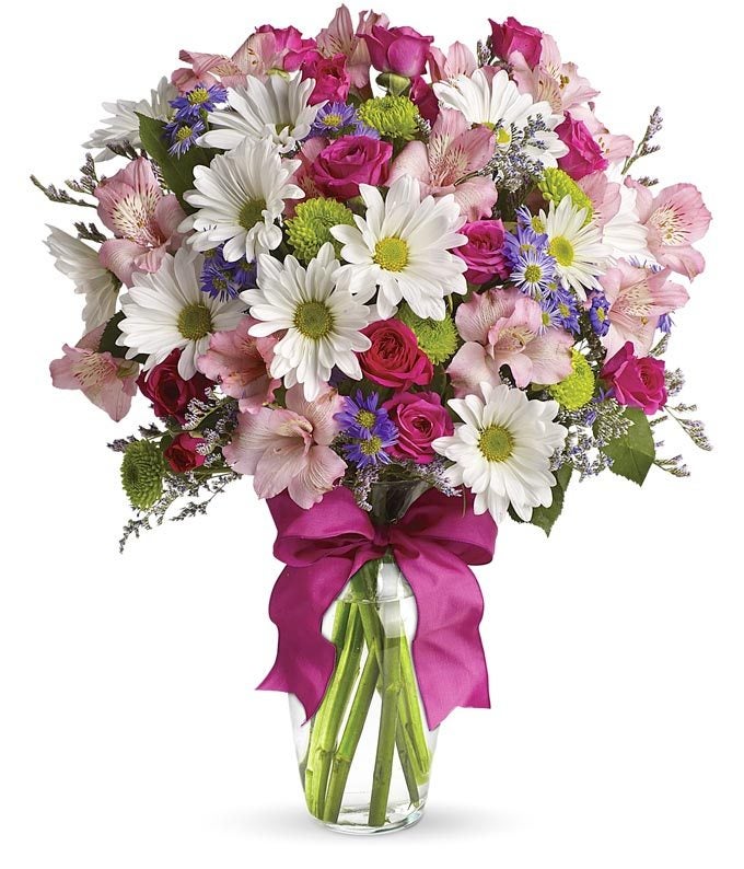 A Bouquet of White Daisies, Pink Spray Roses, Purple Monte Casino Asters, and Green Button Spray Mums in a Clear Glass Vase