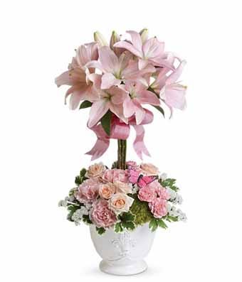 Topiary flower arrangement with pale pink lilies and carnations in white pot 