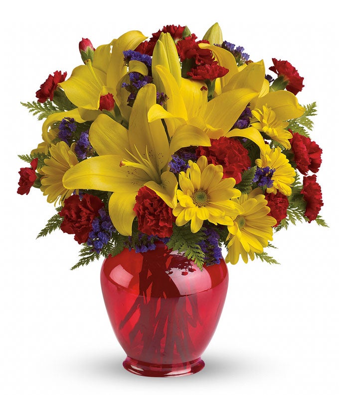 A Bouquet of Yellow Asiatic Lilies, Red Mini Carnations, Yellow Daisy Mums and Purple Statice in a Red Ginger Jar