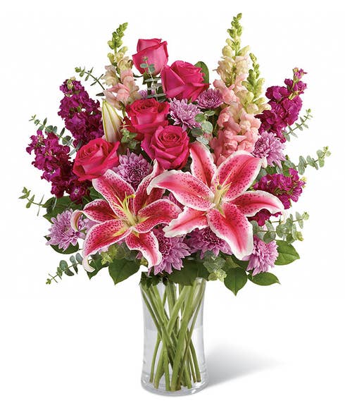 Stagrazer lilies and hot pink roses with purple stock flowers and lavender chrysanthemums