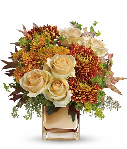 Romantic fall flower bouquet in bronze vase with pale peach roses and mums