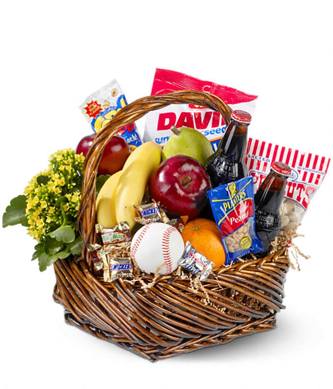 Small Bag of Regular And Shelled Peanuts, Sunflower Seeds, Corn Nuts, Assortment of Fresh Fruits, Mini Candy Bars, Bottles of Root Beer and Mini Kalanchoe Plant in a basket with a Baseball ball
