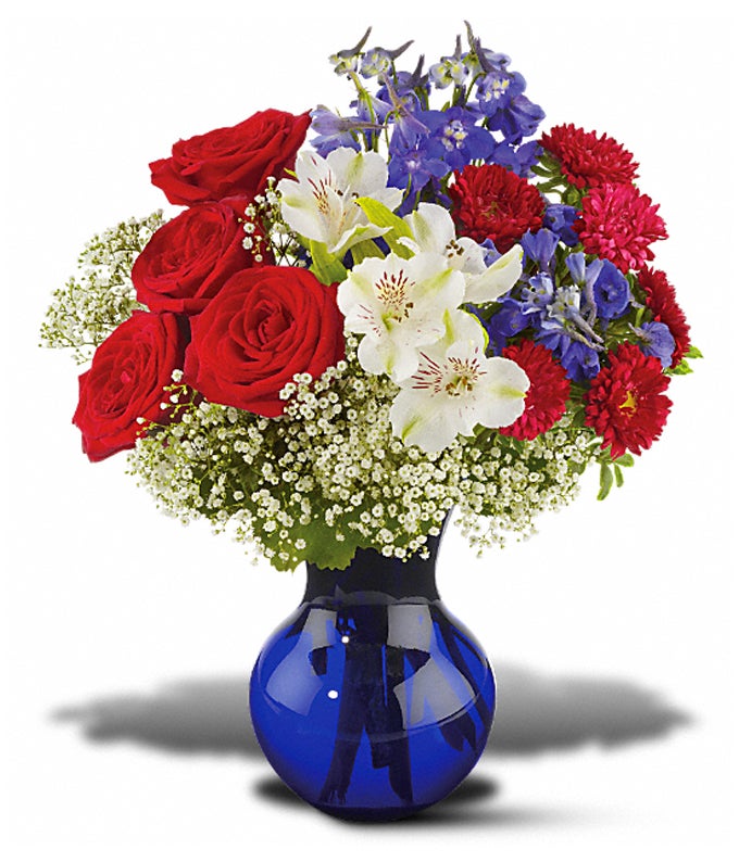 A Bouquet of Red Roses, White Alstroemeria, Red Matsumoto Asters, Million Star Gypsophila, Dark Blue Delphinium and Oregonia in a Dark Blue Vase
