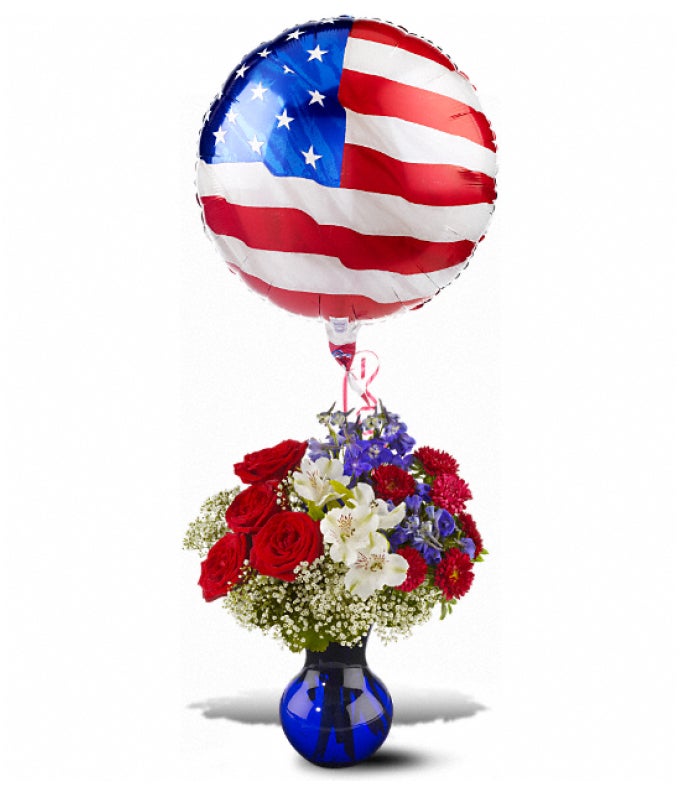 A Bouquet of Red Roses, White Alstroemeria, Red Matsumoto Asters, Million Star Gypsophila, Dark Blue Delphinium and Oregonia in a Dark Blue Vase with 1 Patriotic-Themed Mylar Balloon