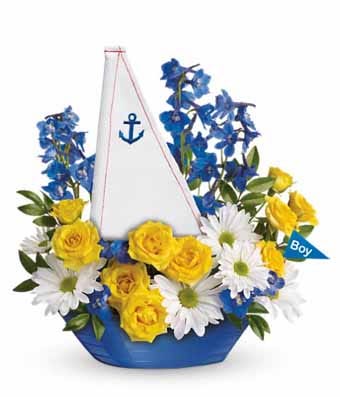 Yellow roses, white daisies and blue delphinium in a boat vase