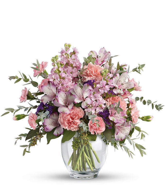 A Bouquet of Lavender Alstroemeria, Pink Carnations, Pink Mini Carnations, Pink Stock and Purple Statice in a Clear Glass Vase