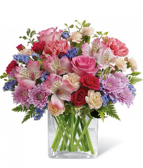 Pink roses and roseate roses bouquet with peach carnations and lavender mums