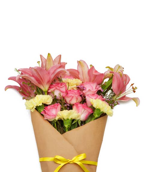 Pink rose and lily wrapped parchment paper wrapped flower bouquet delivery