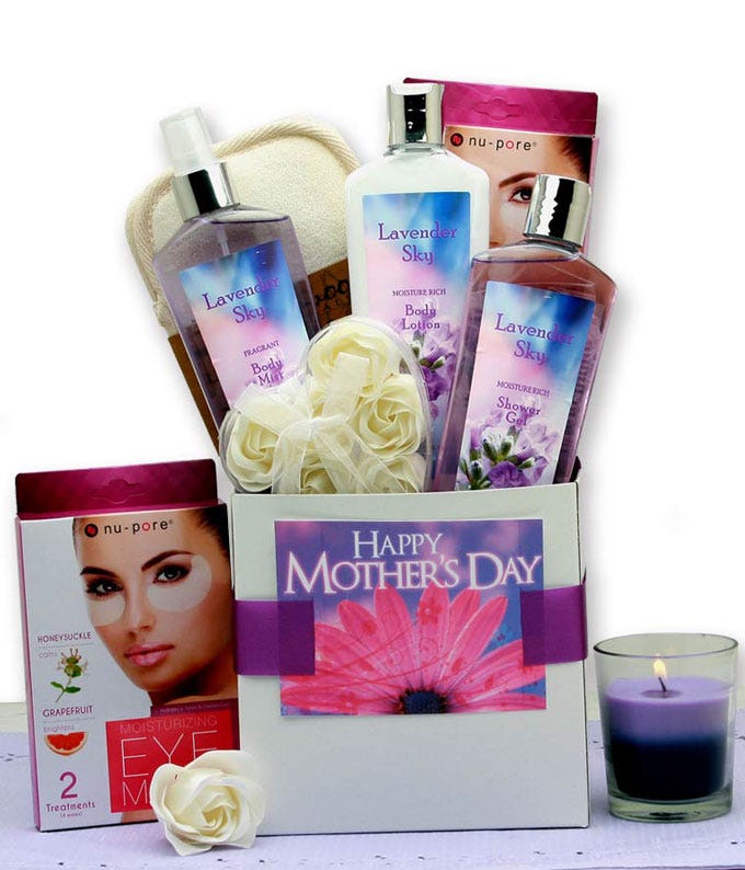 Mother's Day lavender spa gift basket with body lotion, bath gel, spray, bath fizzies, candle, and sponge in a decorated box with a card and personalized message.